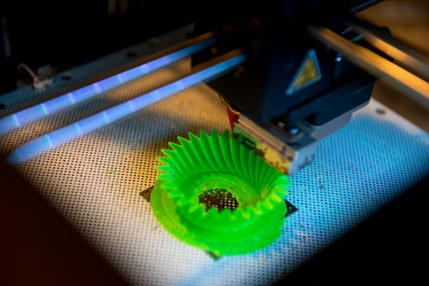 Green spiral component being printed using a 3d printer